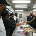 President, VP and spouses assist food kitchen for holiday